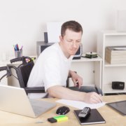 A man in a wheelchair with assistance technologies