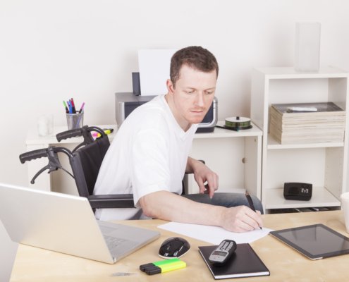 A man in a wheelchair with assistance technologies
